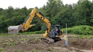 excavator digging in a field
