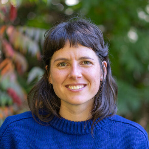 woman in blue sweater smiling at camera
