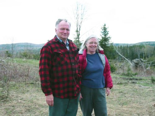 Elderly couple standing outside with hills in distance - Matsingers in Danville Vermont 