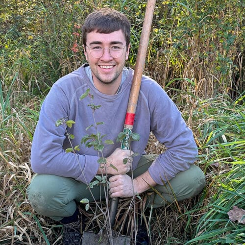 man with shovel and sapling