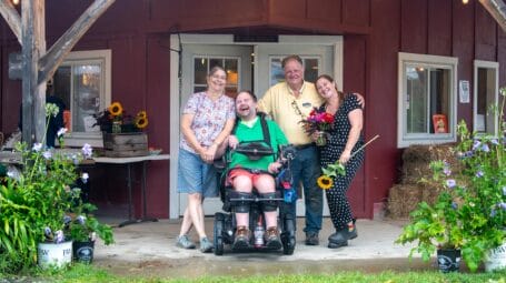 the tisbert family in front of the farm store: anne jay joe and becky