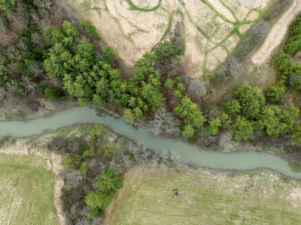 aerial view of river flowing through springtime landscape. Site of trees planted in 2024. Shoreham Vermont