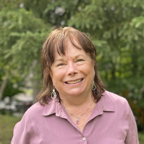 woman in pink shirt smiling