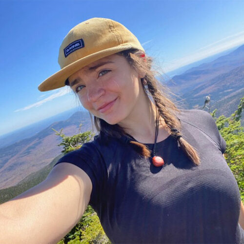 young woman taking a selfie on a mountain top