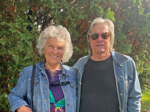 a couple smiles at camera.