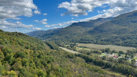 A view of the Winooski valley in Bolton. Mountains are visible in the background, with roads in the foreground.